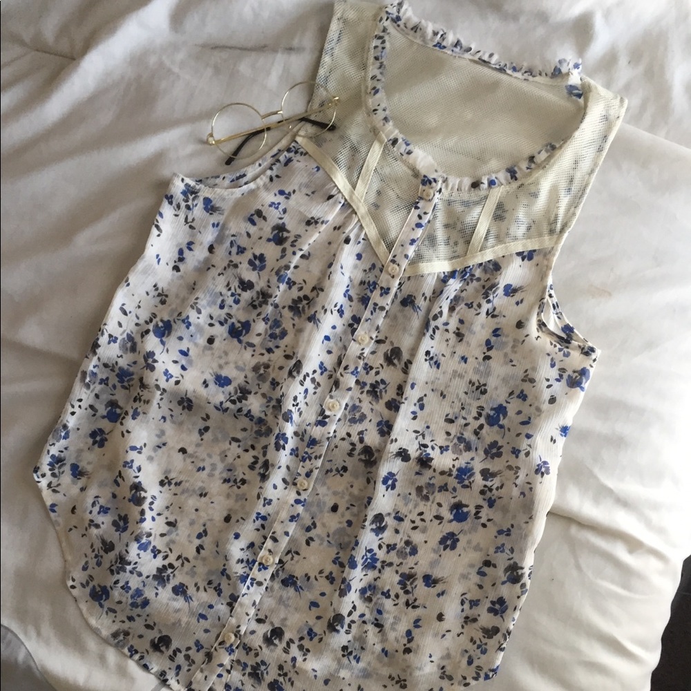 Sleeveless floral blue and cream colored blouse